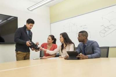 People examining a 3D printed prototype