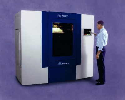 A man operating the FDM Maxum 3D Printer