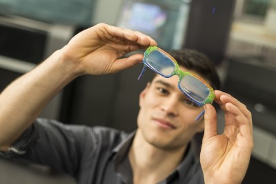 A man examining 3D printed eye-glasses